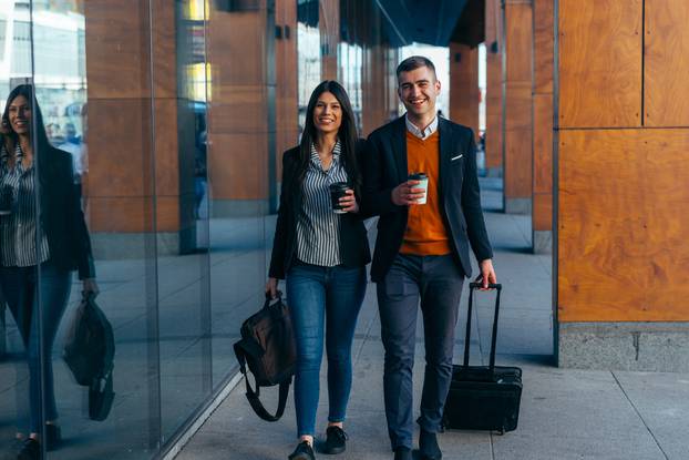 Bussiness,Couple,Walking,Through,A,Futuristic,Modern,Station