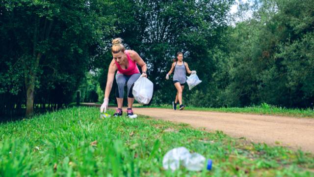 Two,Girls,Picking,Up,Trash,While,Plogging,Outdoors