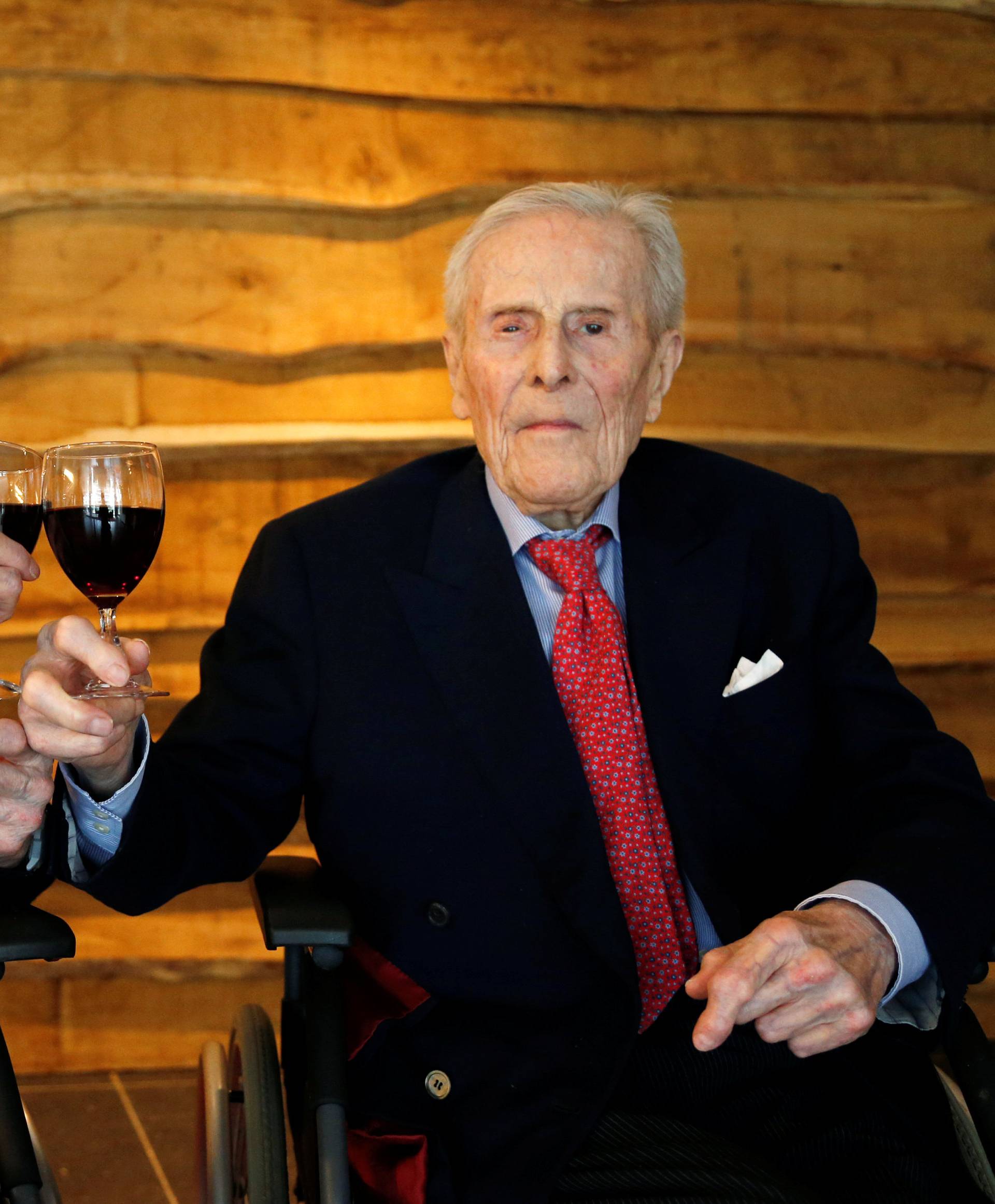 The world's oldest living twin brothers, Paulus and Pieter Langerock from Belgium, 102, toast with a glass of red wine at the Ter Venne retirement home in Sint-Martens-Latem