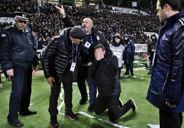 Olympiacos coach Oscar Garcia reacts after his injury during a Greek Super League soccer match between PAOK and Olympiacos in Thessaloniki