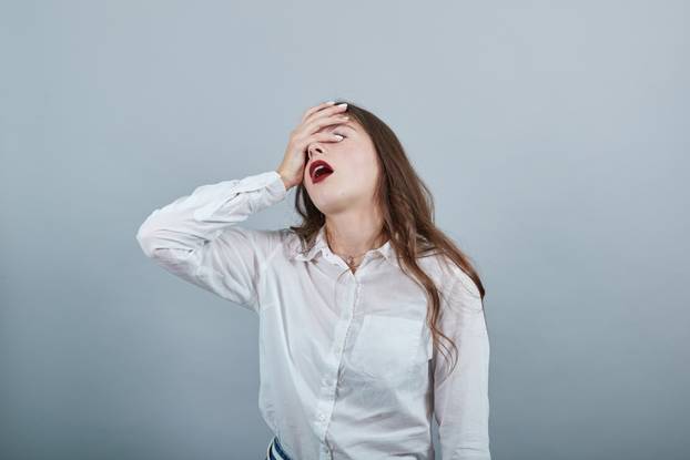 Boring sickness young woman keeping hand on forehead, having headache
