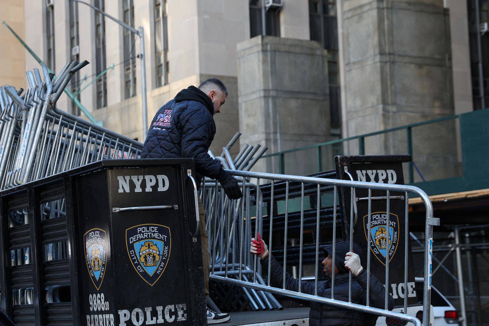 Men set up NYPD barricades outside Manhattan Criminal Court in New York City