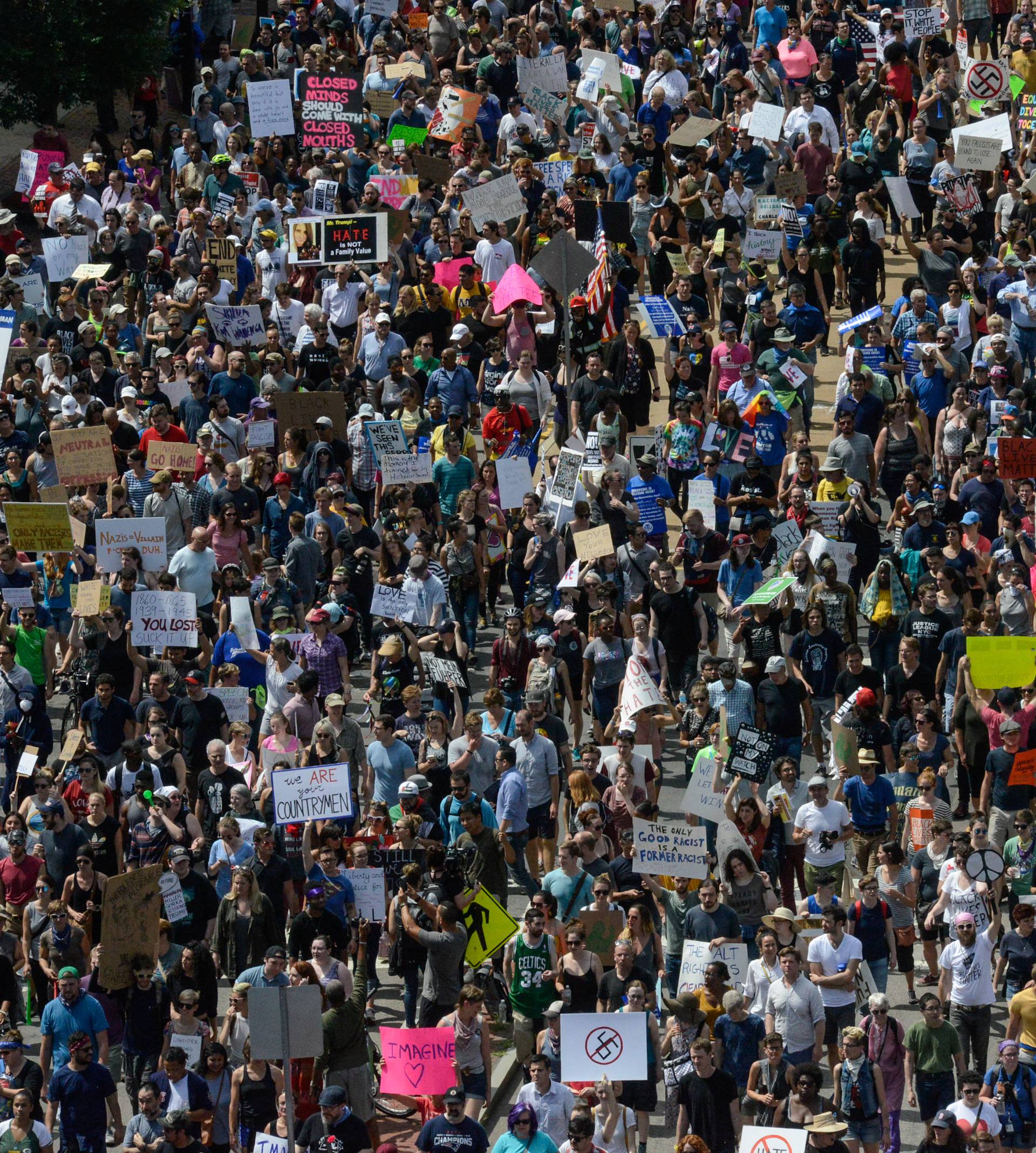 A large crowd of people march towards the Boston Commons to protest the Boston Free Speech Rally in Boston, MA