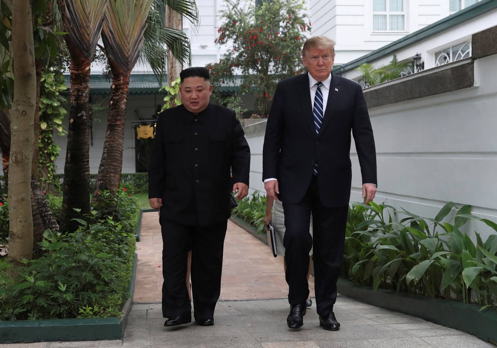 U.S. President Donald Trump and North Korea's leader Kim Jong Un walk in the garden at the Metropole hotel during the second North Korea-U.S. summit in Hanoi