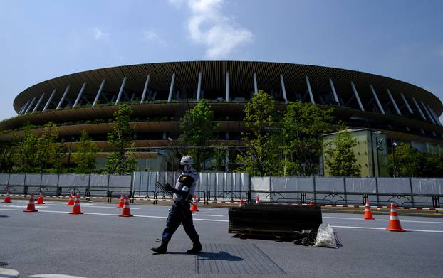 Workers install additional security fence outside Olympic Stadium (National Stadium) for the 2020 Tokyo Olympic Games