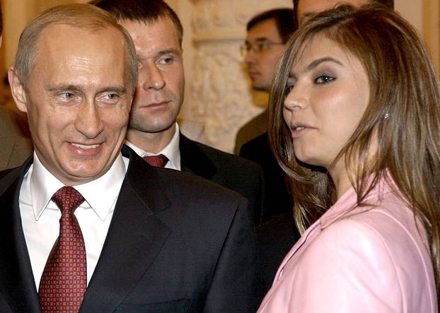 FILE PHOTO: File photo of Russian President Vladimir Putin smiling next to Russian gymnast Alina Kabaeva during a meeting with the Russian Olympic team at the Kremlin in Moscow