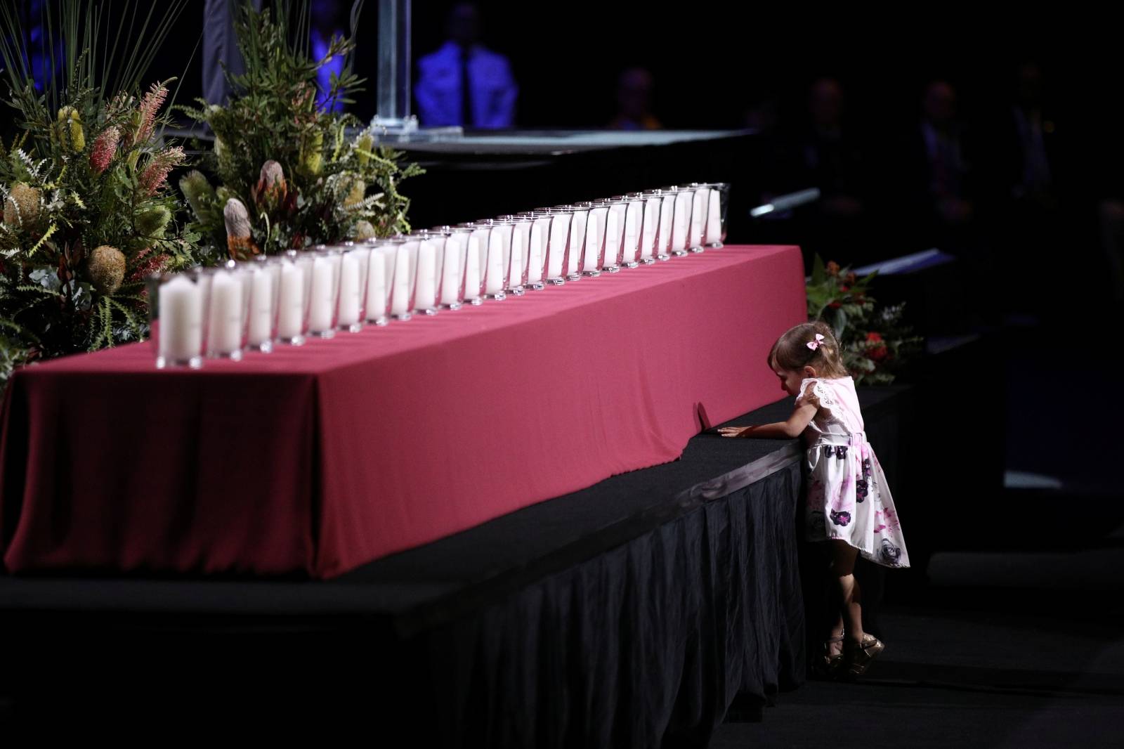 A young girl from the family seating section approaches a memorial honouring the victims of the Australian bushfires in Sydney