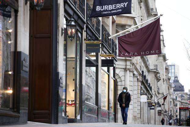 FILE PHOTO: People walk along Regent Street as shops remain closed under Tier 4 restrictions, amid the coronavirus disease (COVID-19) outbreak, in London