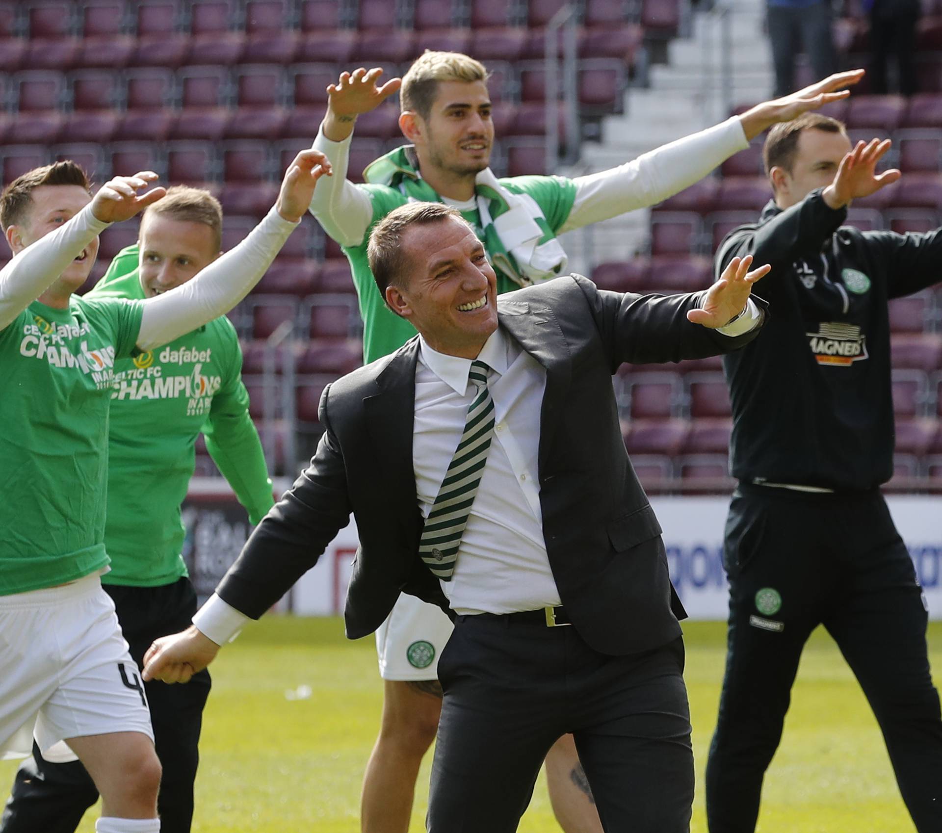 Celtic manager Brendan Rodgers and their players celebrate winning the Scottish Premiership