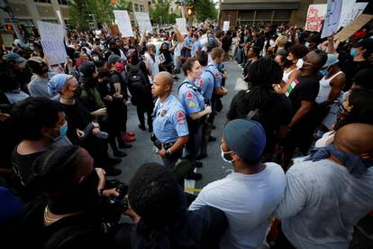 Protesters completely surround a line of police officers during nationwide unrest following the death in Minneapolis police custody of George Floyd, in Raleigh