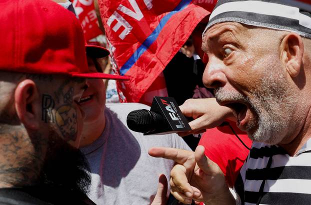 A supporter of former U.S. President Donald Trump and an anti-Trump demonstrator argue near the Wilkie D. Ferguson Jr. United States Courthouse