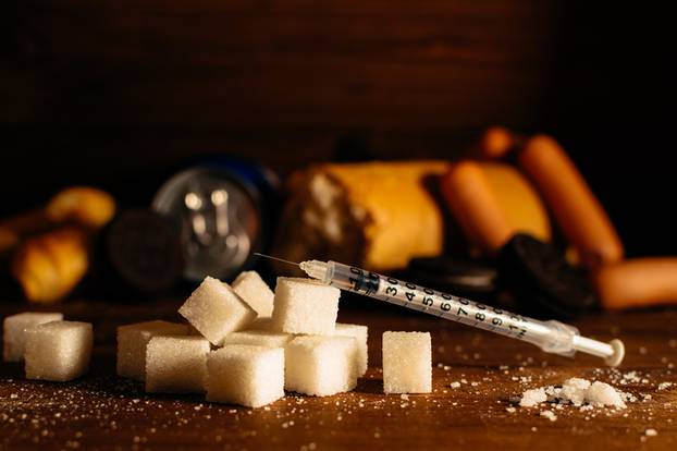 Disease - diabetes. Sugar, syringe for injection, harmful food 
