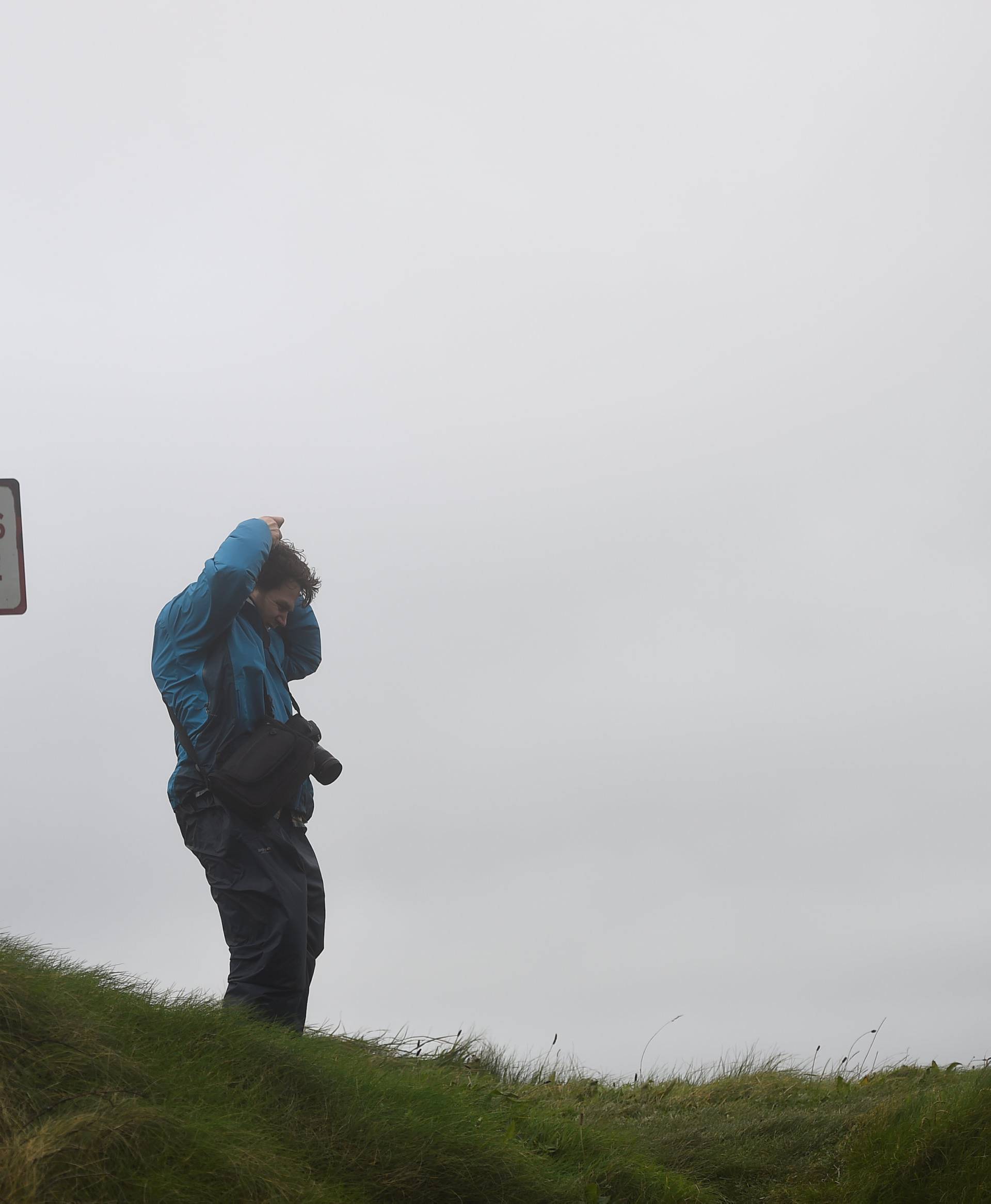 A man stands on a coastal cliff edge in the County Clare town of Lahinch