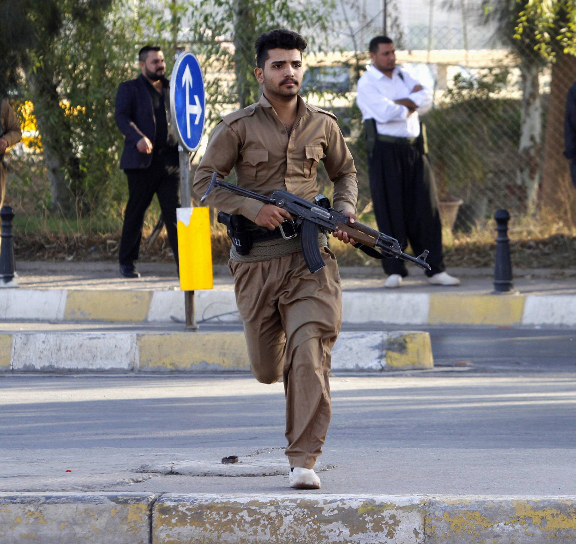 A member of peshmerga forces runs at a site of an attack by Islamic State militants in Kirkuk
