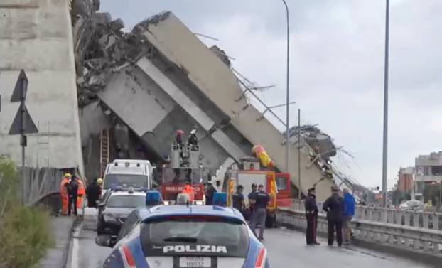 Rescue workers are seen at the collapsed Morandi Bridge in the Italian port city of Genoa