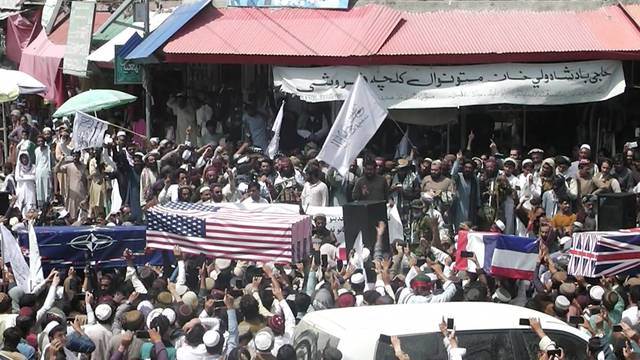 U.S. and NATO flags flank coffins at mock funeral held by Taliban