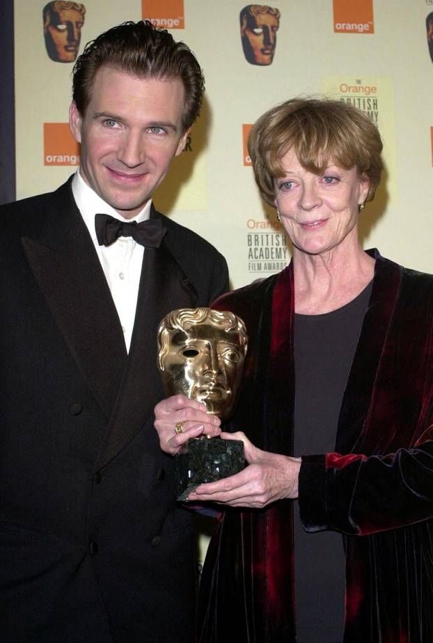 FILE PHOTO: Maggie Smith holds her BAFTA (British Academy of Film and Television Awards) award, in London