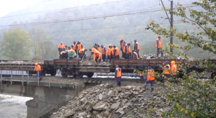 A still image taken from a video footage shows emergency service workers unloading stones on a railway bridge following a recent flood in Krasnodar Region