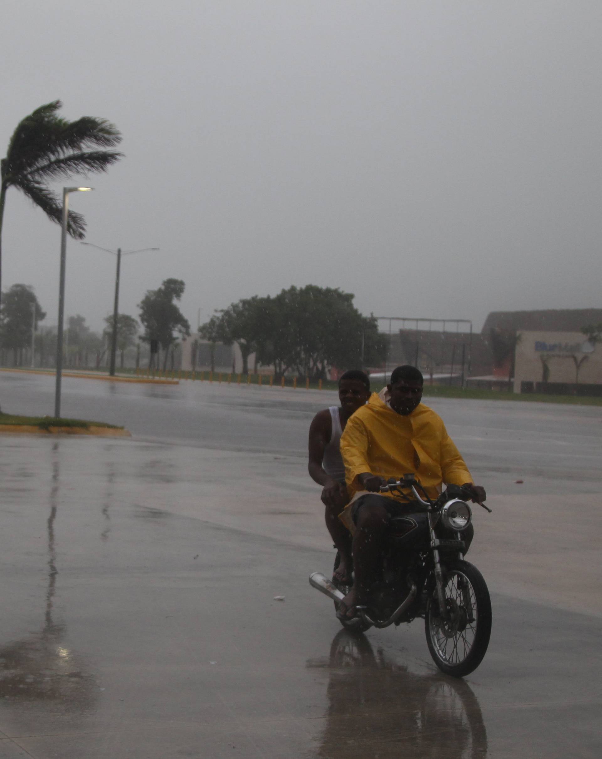 People ride a motorbike on the street before the arrival of Hurricane Maria in Punta Cana