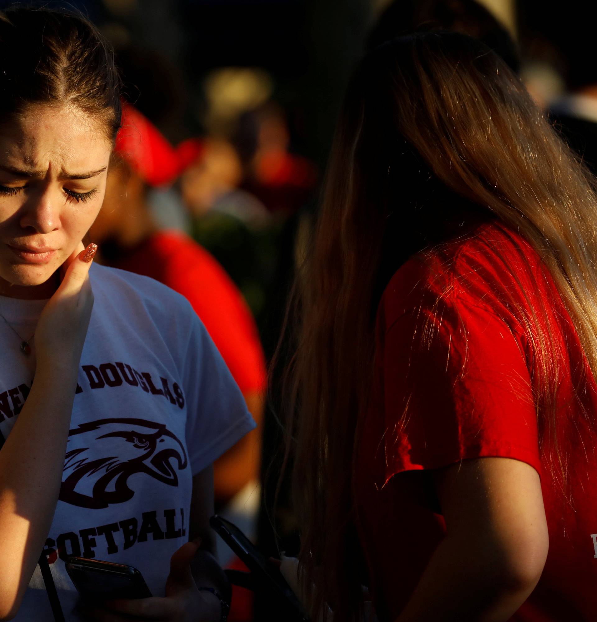 Student mourns during a candlelight vigil for victims of yesterday's shooting at nearby Marjory Stoneman Douglas High School, in Parkland