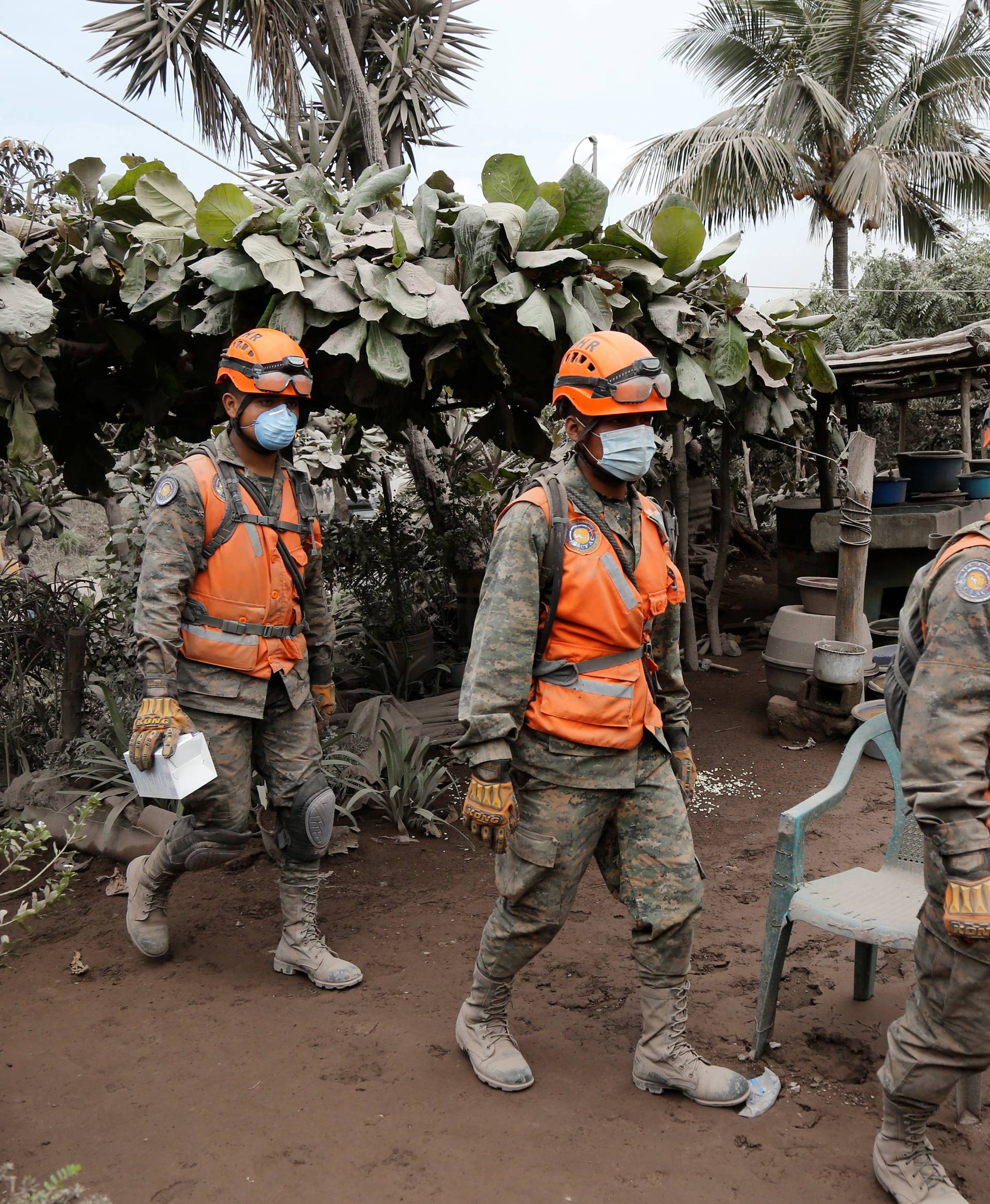 Soldiers inspect an area affected by the eruption of the Fuego volcano in the community of San Miguel Los Lotes in Escuintla