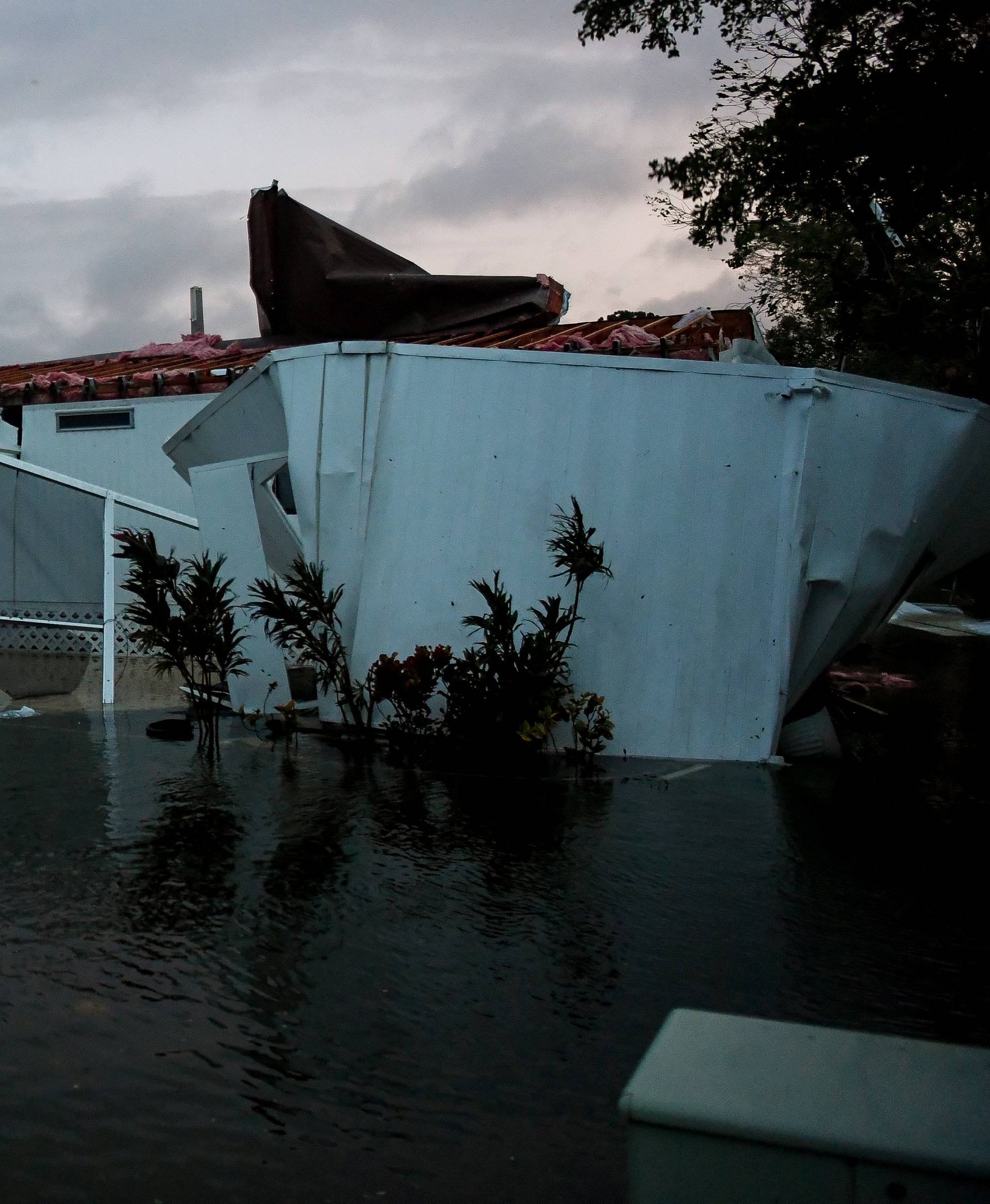 Flood water from Hurricane Irma surround a damaged mobile home in Bonita Springs