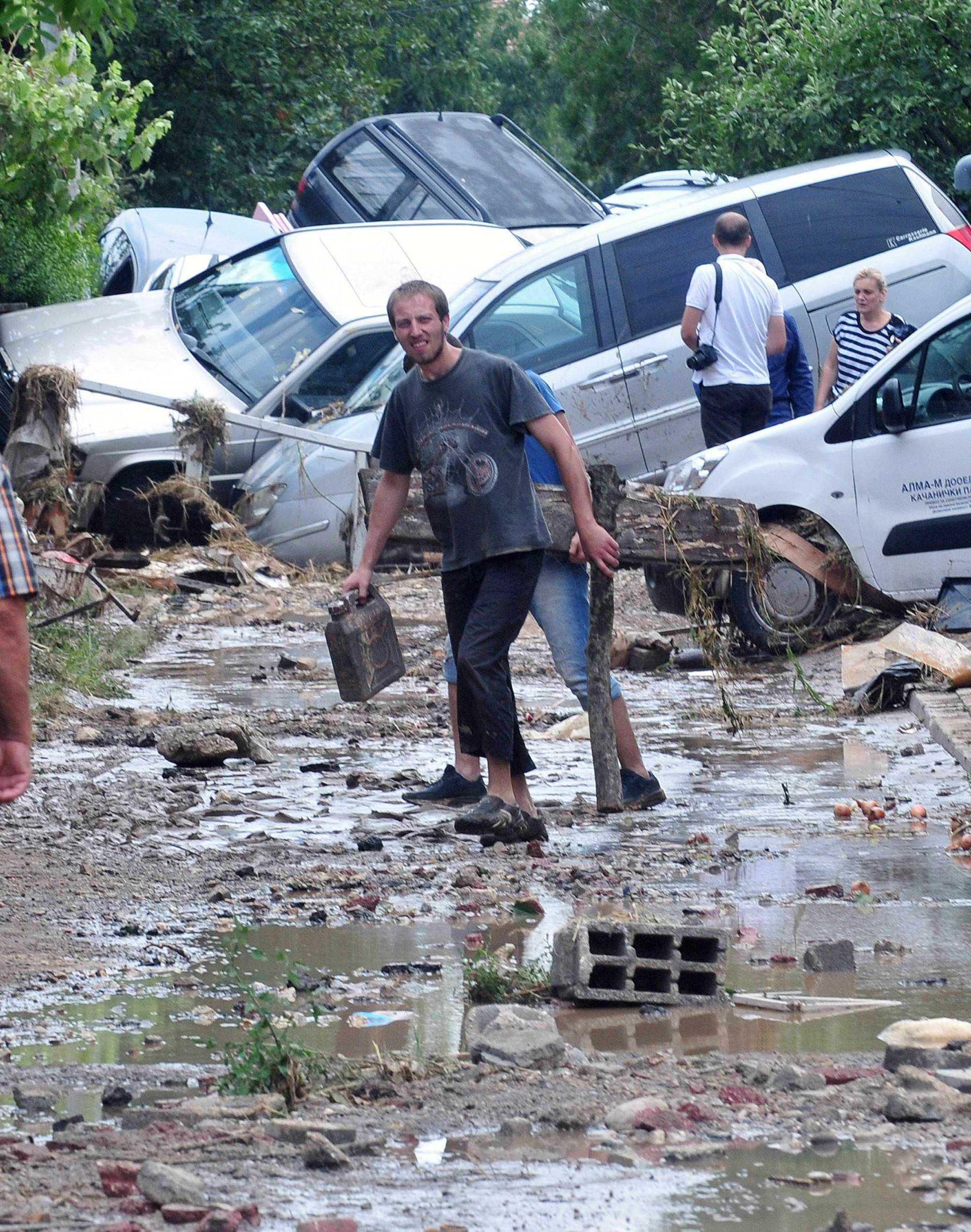 People walk on the streets after heavy floods in Cento near Skopje