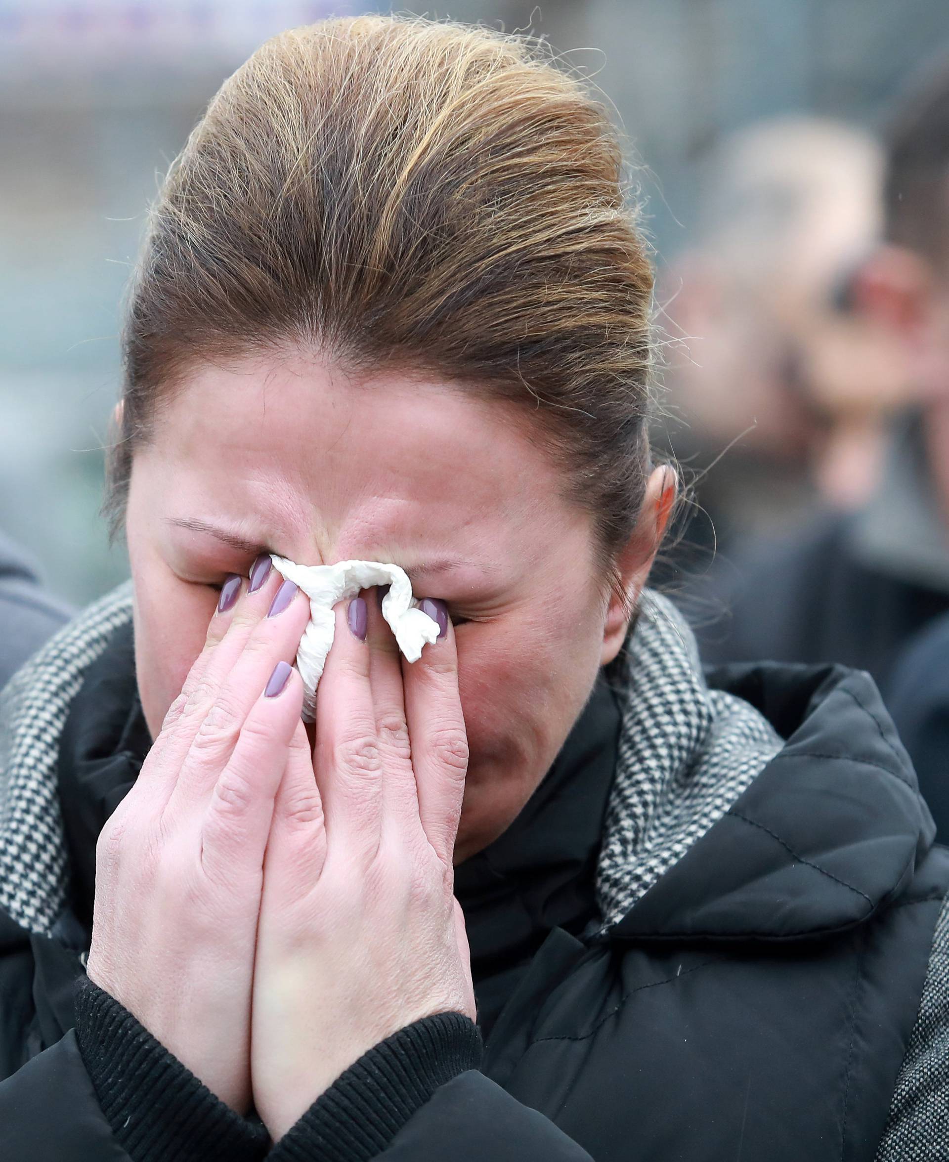 Mourners cry as a cortege escorts a car carrying coffin of Oliver Ivanovic travels to the northern outskirts of Kosovska Mitrovica