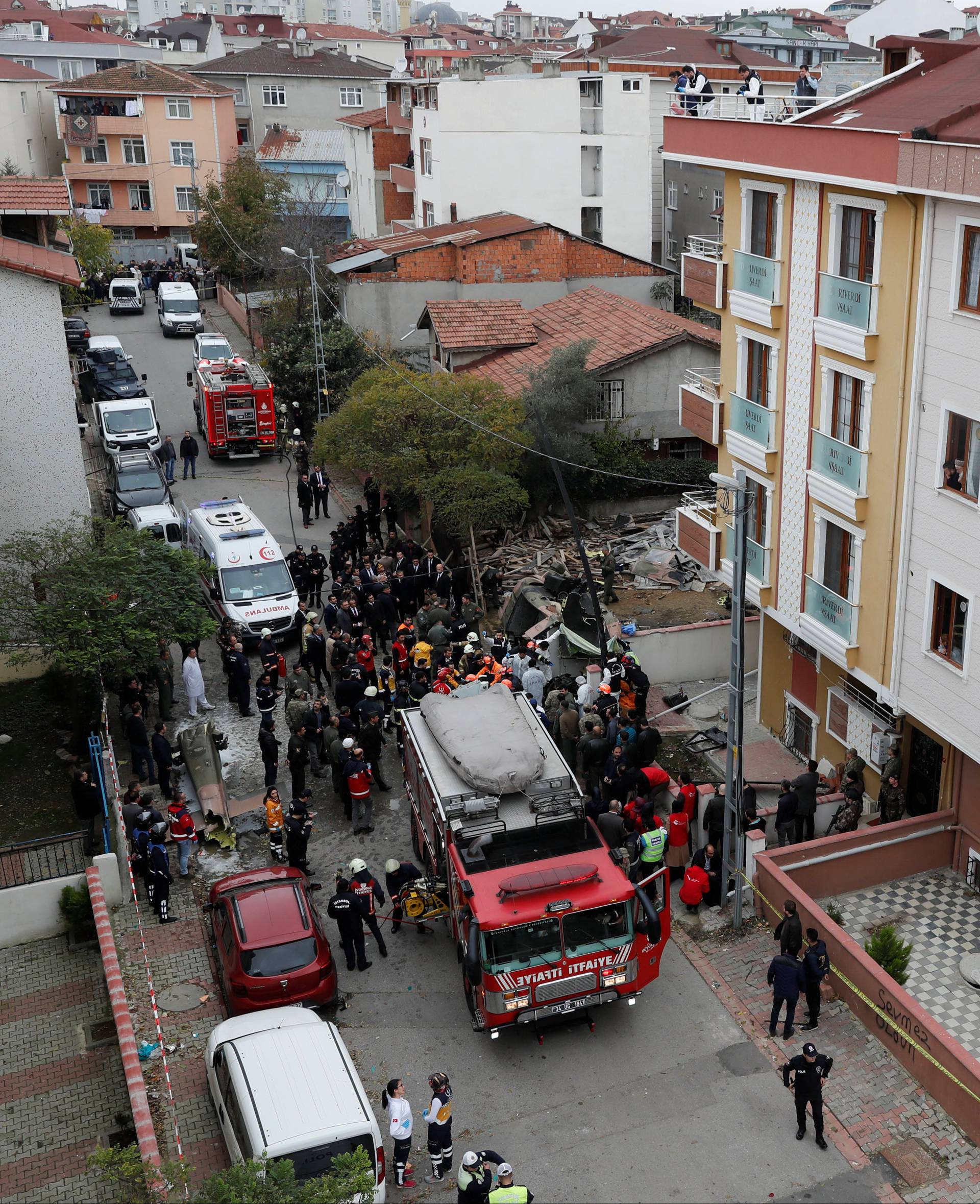 Rescue workers and investigators work at the site of a helicopter crash in Istanbul