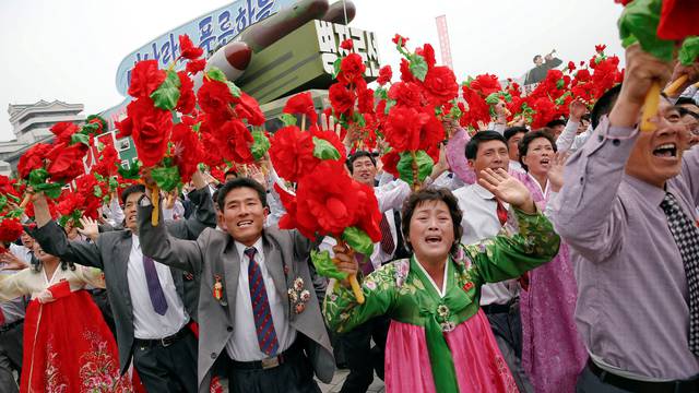 People react as they see North Korean leader Kim Jong Un during a mass rally and parade in Pyongyang
