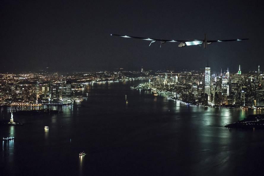 Solar Impulse 2, the solar airplane, piloted by Swiss adventurer Andre Borschberg, flies approaches Manhattan and the Statue of Libery in in New York, shortly before landing at John F. Kennedy airport