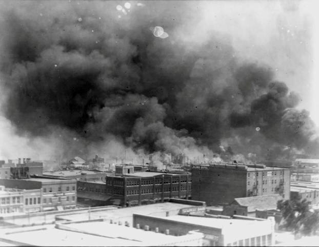 Smoke rises from buildings during the 1921 race massacre in Tulsa