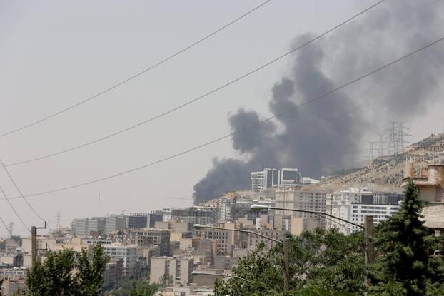 Smoke rises following what Iran says was an Israeli attack on Sharan Oil depot in Tehran