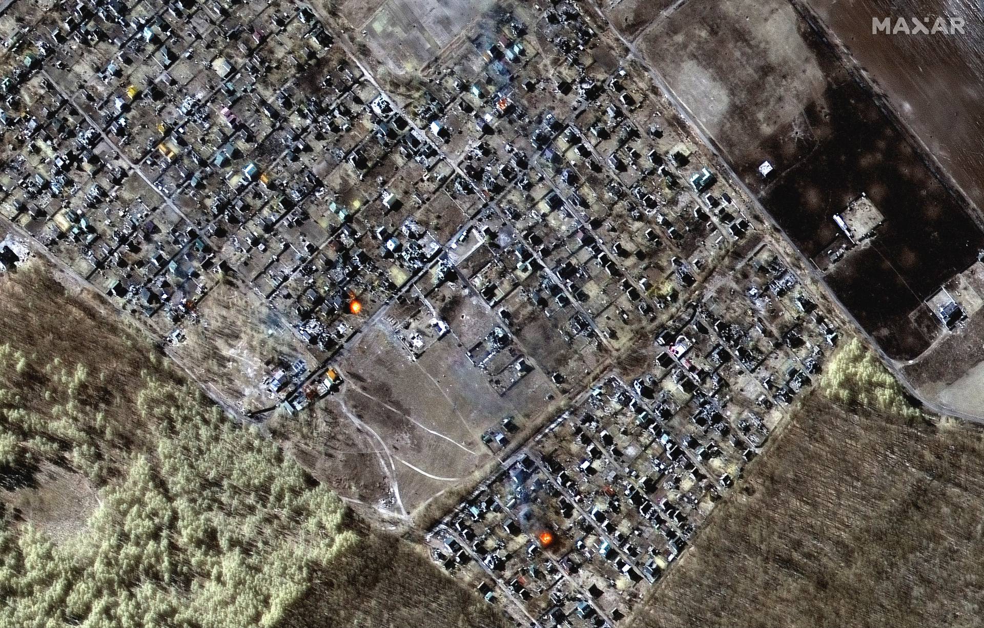 A satellite image shows a multispectral overview of burning homes, in Moschun