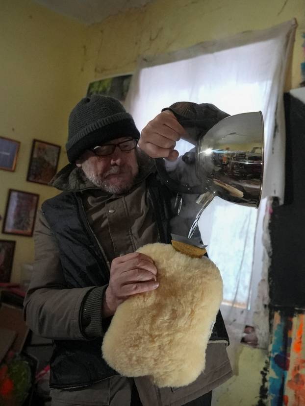 Ukrainian artist works at his studio during a power blackout in Kyiv