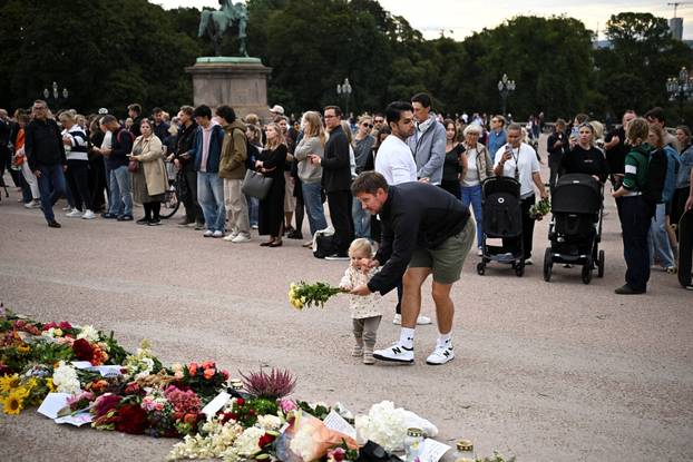 People gather outside the Royal Palace, following the death of Norway's King Harald, in Oslo