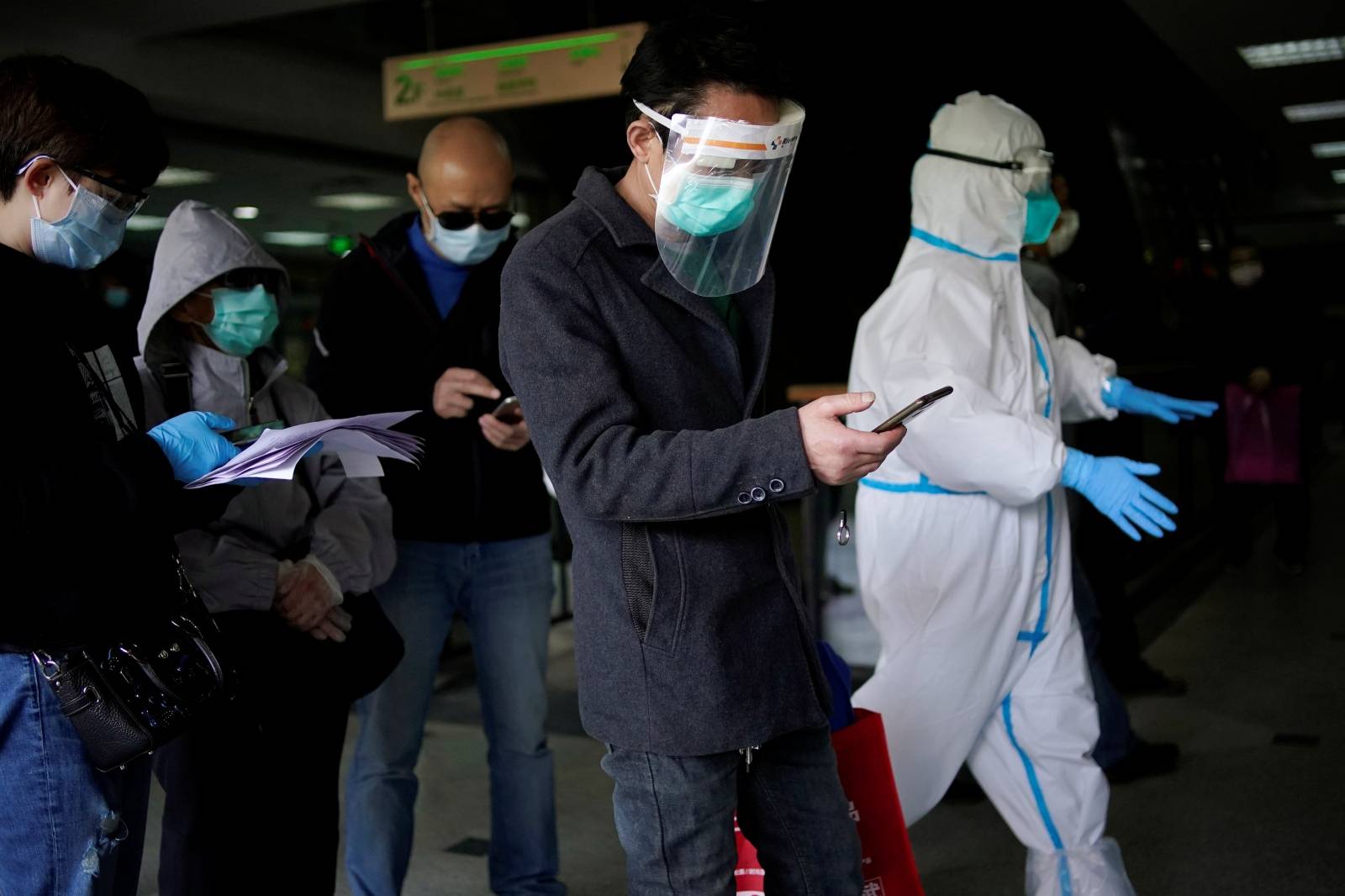Trader He Ximing, 52, a recovered COVID-19 patient who tested positive for the virus' antibodies after a number of negative tests, walks past a blocked fresh food market after the lockdown was lifted in Wuhan