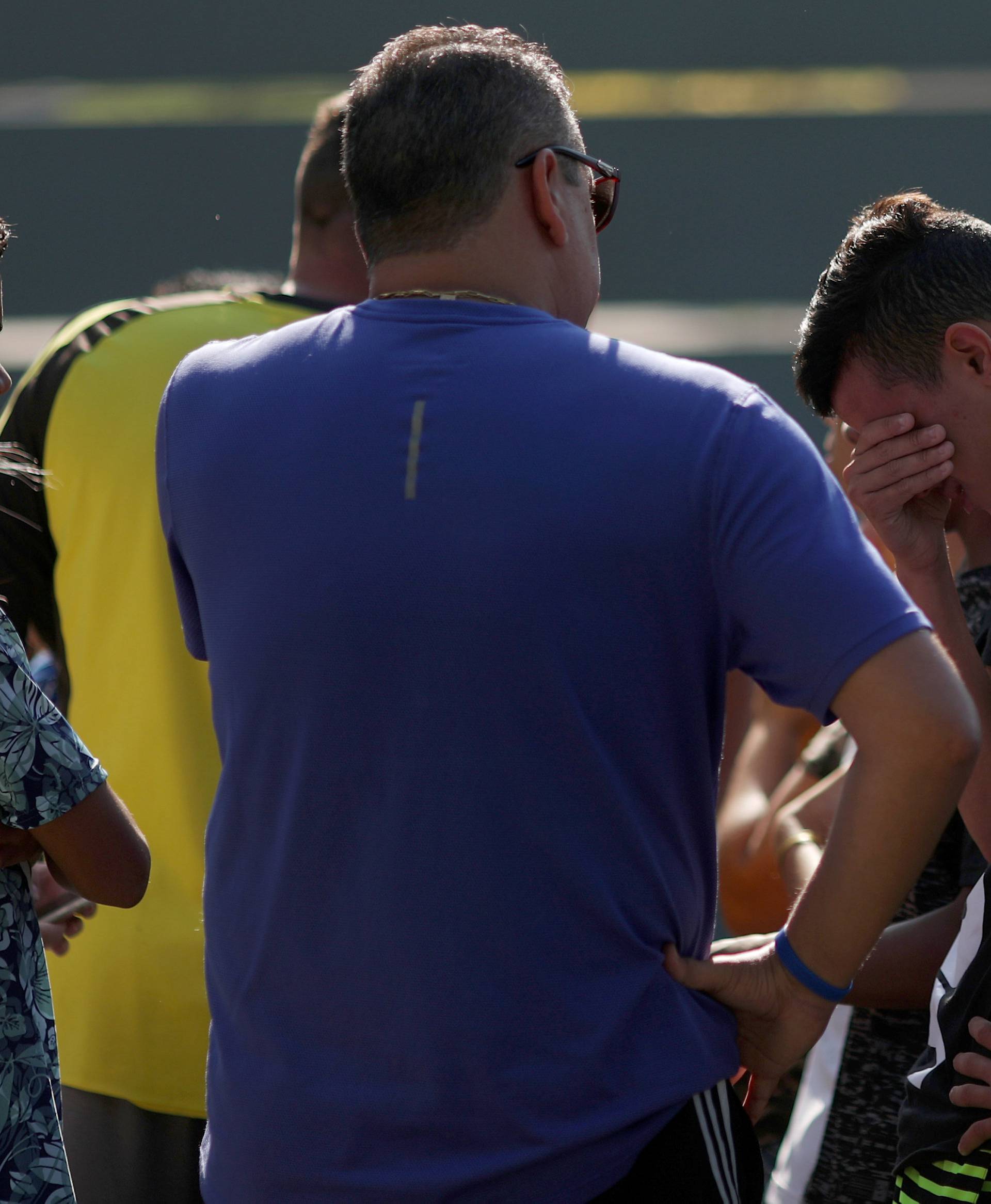 People wait for information at Flamengo training centre after deadly fire in Rio de Janeiro