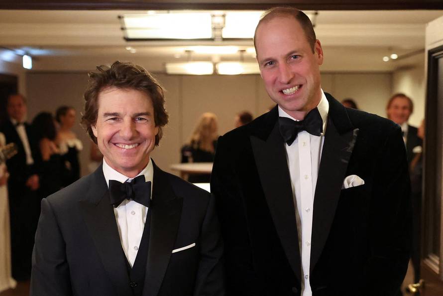 Britain's Prince William, Prince of Wales, poses for a photo with U.S. actor Tom Cruise, at the London Air Ambulance Charity Gala Dinner at The OWO, in central London