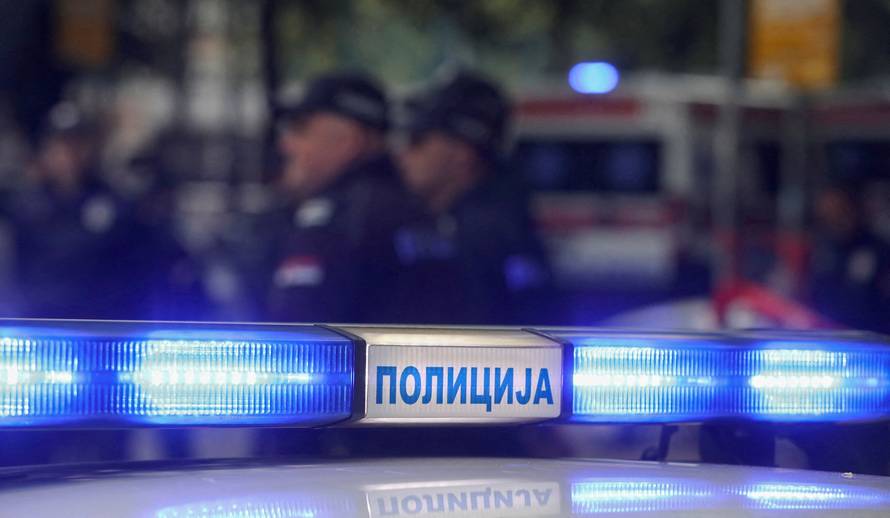 Police officers secure the area after a 14-year-old boy opened fire on other students and security guards at a school in downtown Belgrade