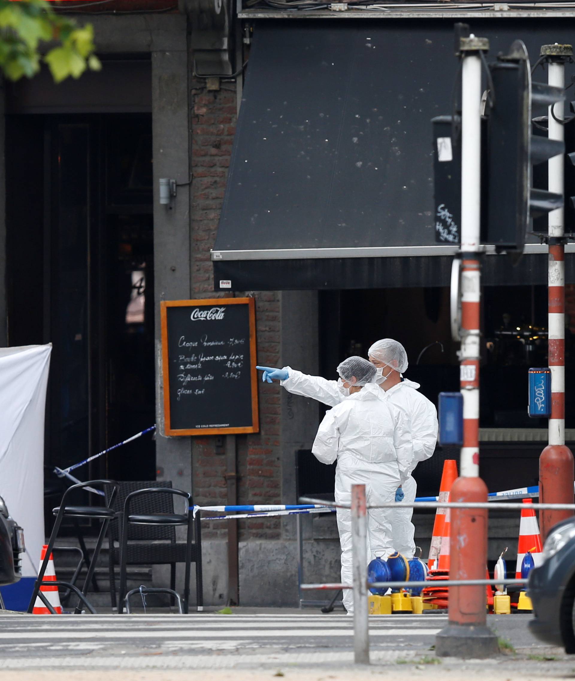 Forensics experts are seen on the scene of a shooting in Liege