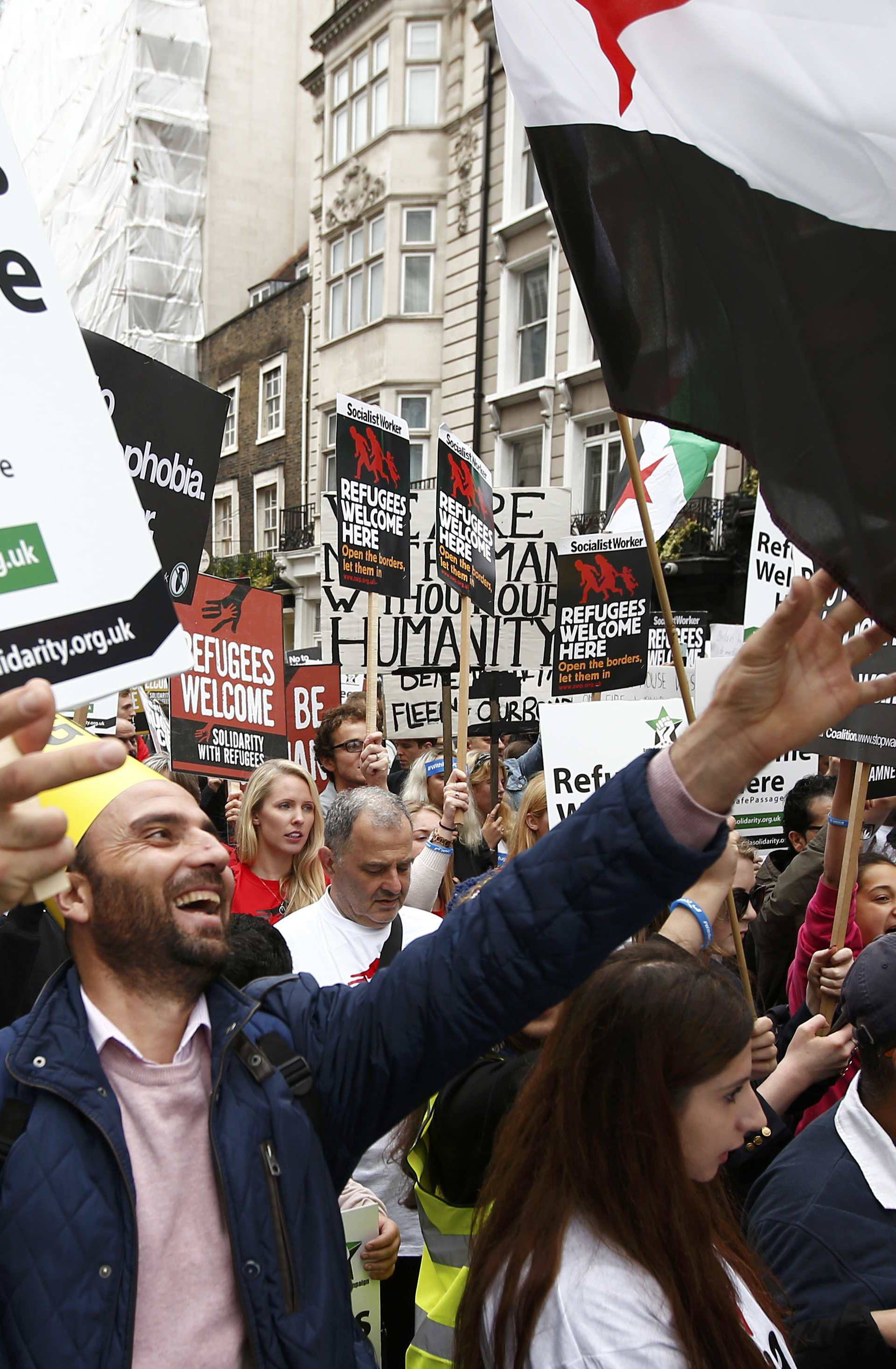 Demonstrators including refugees march to the Houses of Parliament during a protest in support of refugees, in London