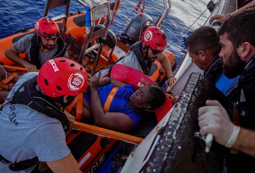 NBA Memphis player Marc Gasol and members of NGO Proactiva Open Arms rescue boat carry an African migrant in central Mediterranean Sea