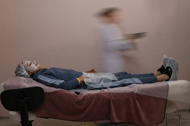 Former Ukrainian service member, who was wounded at a front line, comes to a clinic to treat scars, in Lviv