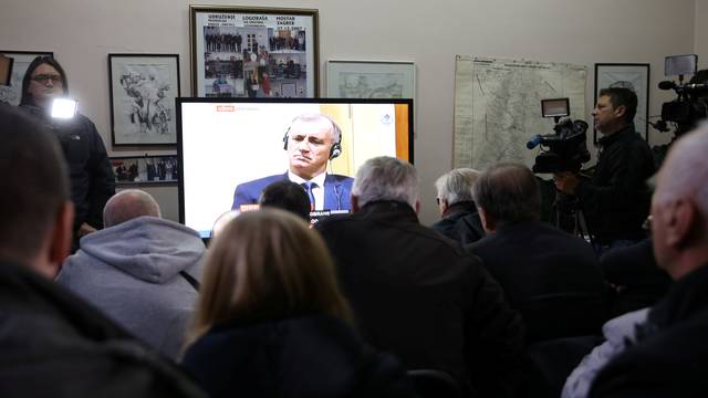 Union of former detainees watch a television broadcast of the appeal trial in the Hague, Netherlands, for six Bosnian Croat senior wartime officials accused of war crimes against Muslims in Bosnia's 1992-1995 war, in Mostar