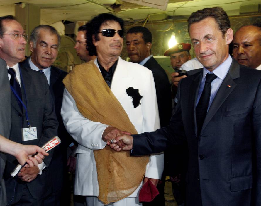 FILE PHOTO: Libya's President  Gaddafi greets his counterpart from France Sarkozy at Bab Azizia Palace in Tripoli