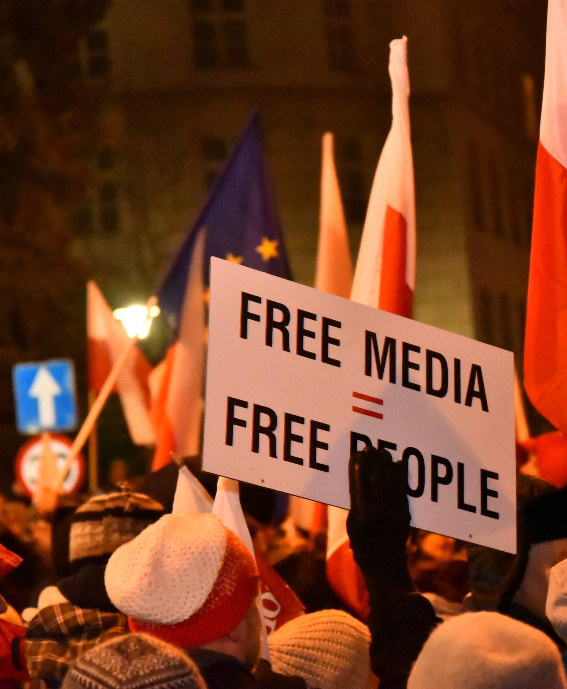 People demonstrate against new restrictions for media at the Polish Parliament in front of the Parliament building in Warsaw,