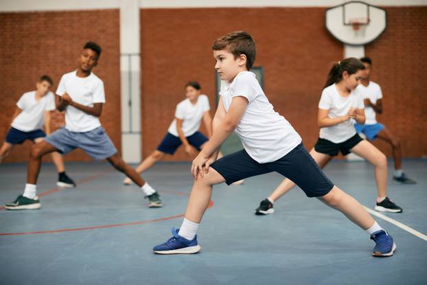 Schoolboy,And,His,Classmates,Doing,Stretching,Exercises,While,Having,During