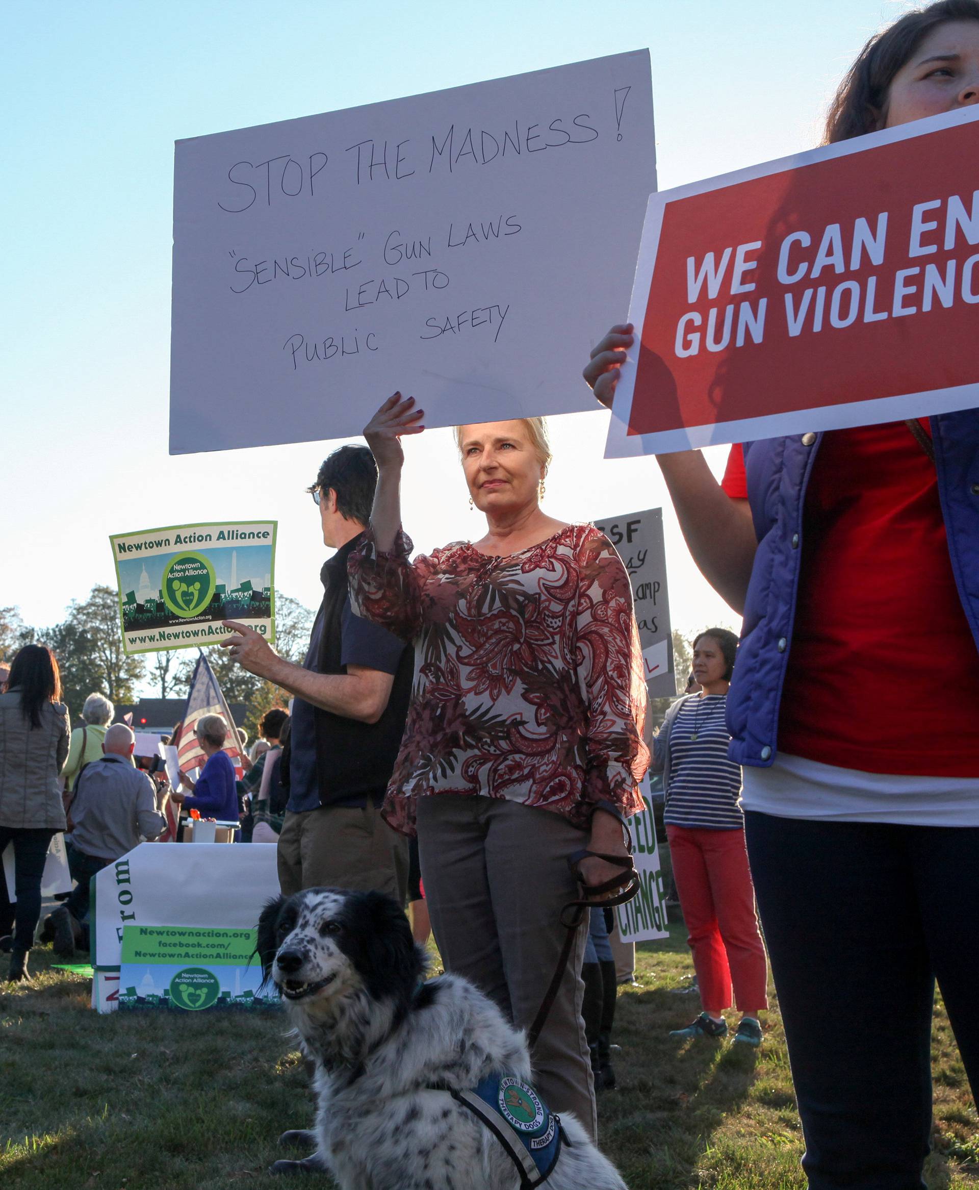 FILE PHOTO: Mourners hold signs during a solidarity vigil in memory of victims of Las Vegas' Route 91 Harvest music festival mass killing, in Newtown