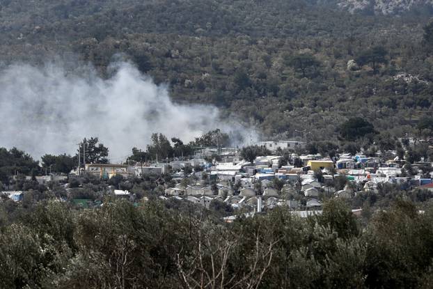 Smoke rises as a fire burns containers used to house refugees and migrants in the Moria camp on the island of Lesbos